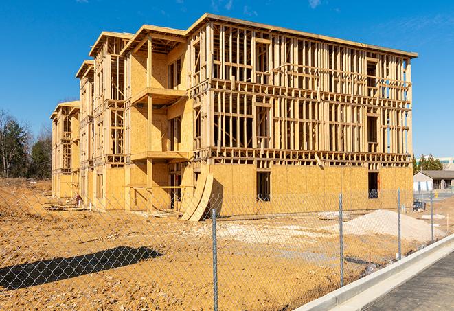 a close-up of temporary chain link fences enclosing a job site, signaling progress in the project's development in Springdale